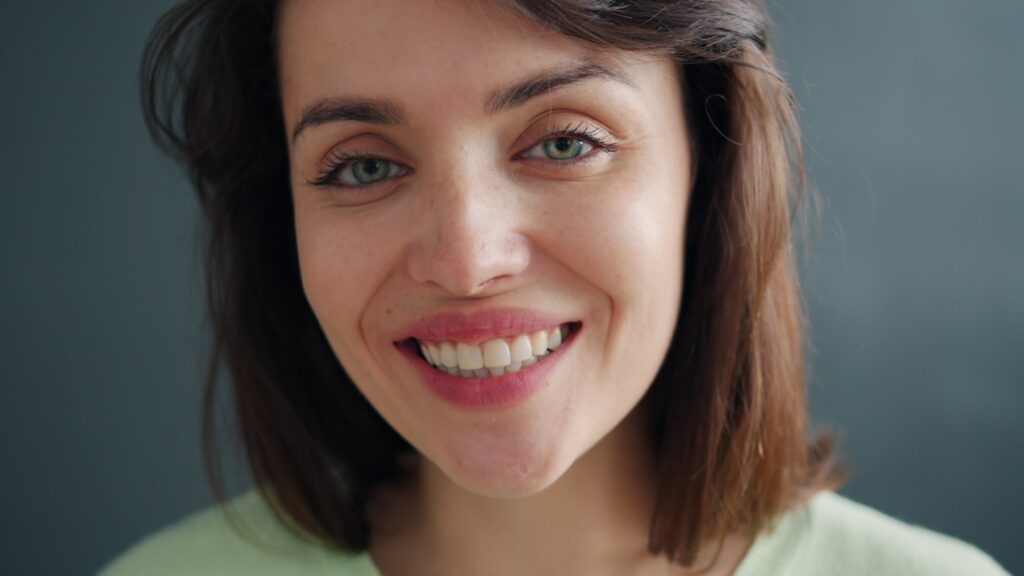 A patient smiling after keeping her natural tooth with root canal treatment