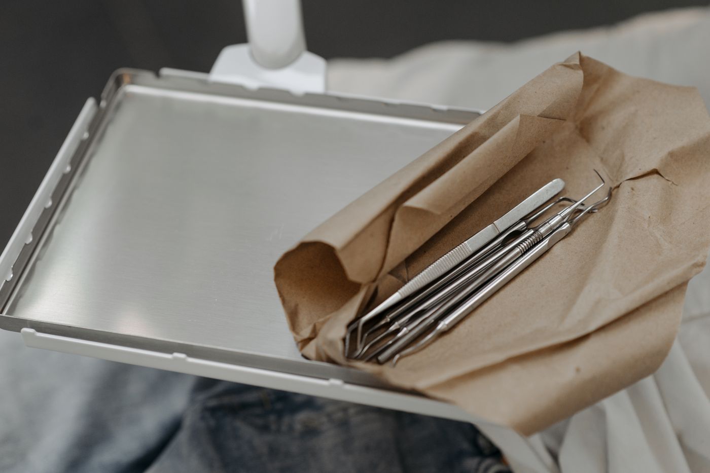 A sterile tray of dental instruments prepared for a tooth extraction